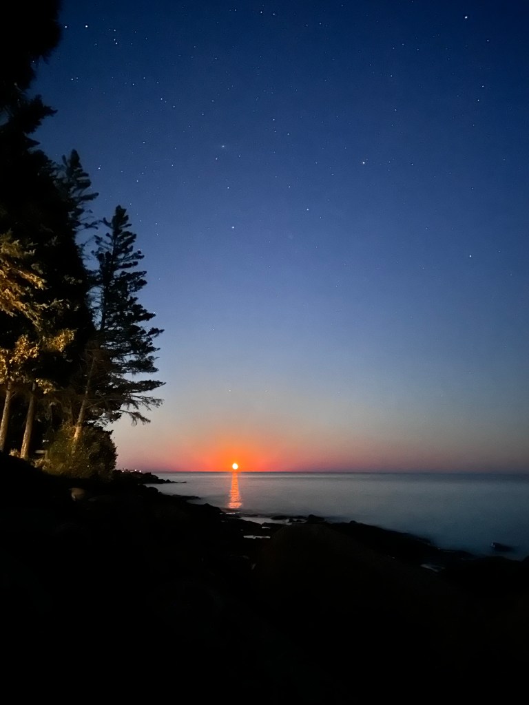 moon rise over Lake Superior under the summer starry sky.