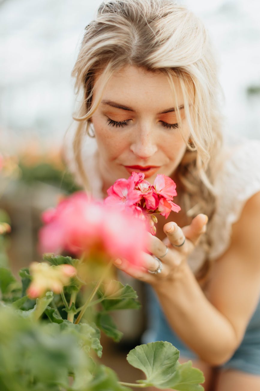 women smelling a flower