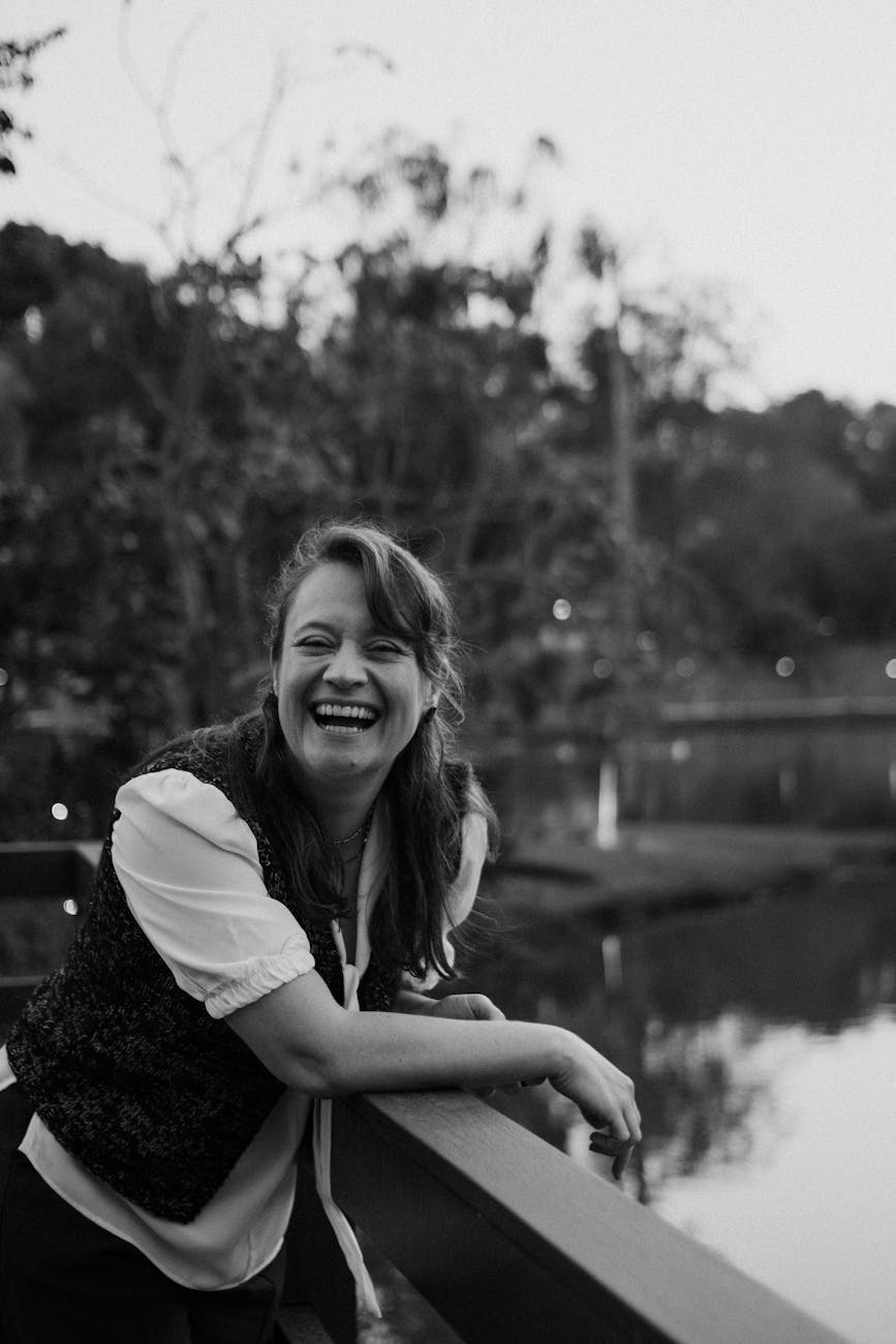 joyful woman laughing outdoors in park